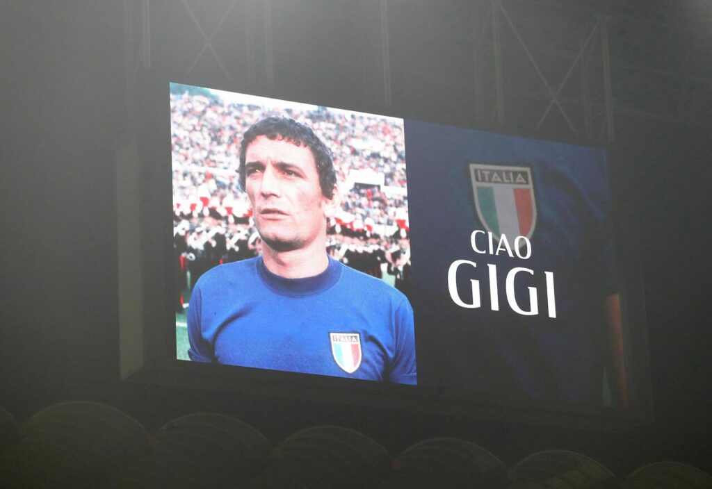 A picture of late Gigi Riva is seen on a giant screen prior the Serie A TIM match between AC Milan and Bologna FC