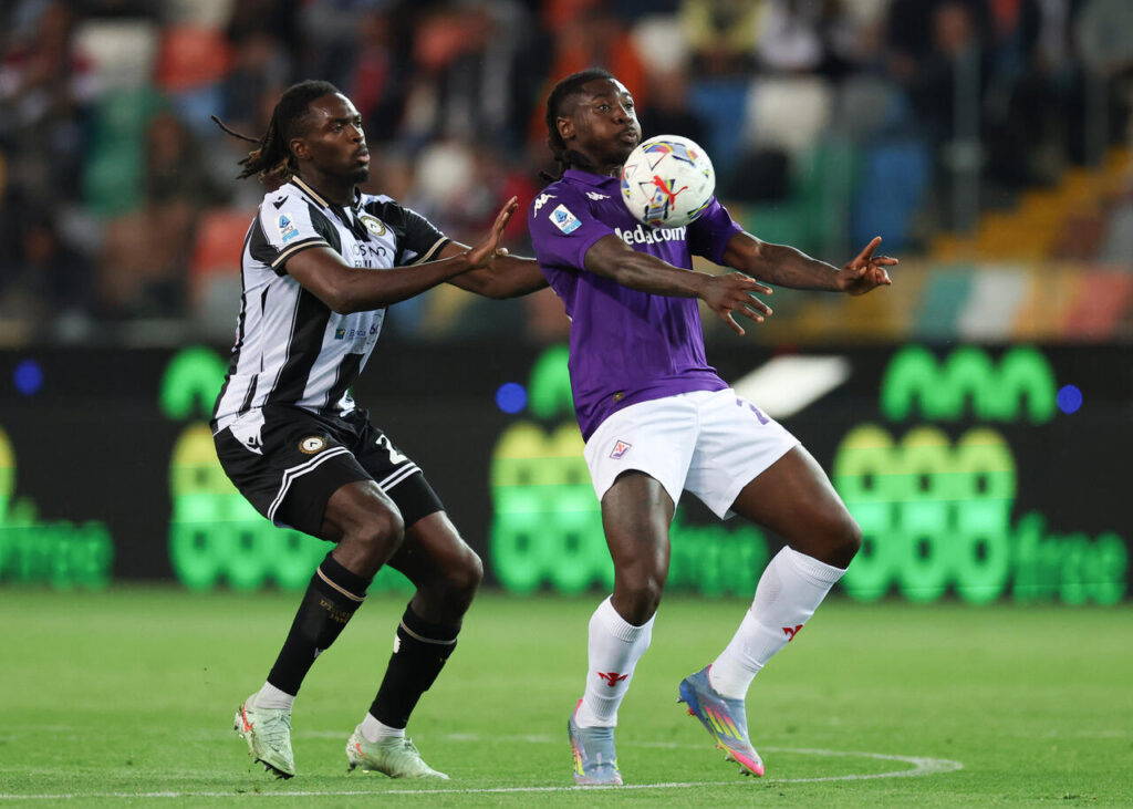 Moise Kean of Fiorentina controls the ball under pressure from Oumar Solet of Udinese